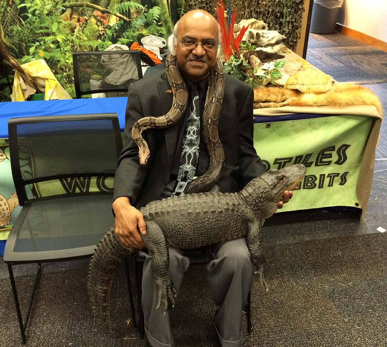Sastry Pantula sitting with snake and crocodile