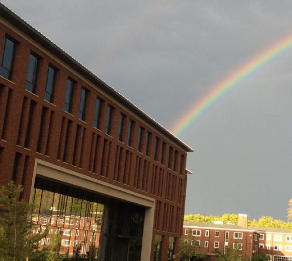A rainbow peering behind Austin Hall.