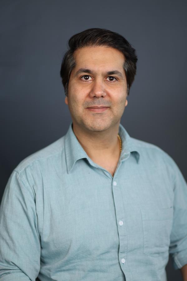 Smiling portrait headshot of Omid