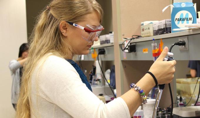 female student working with samples in lab