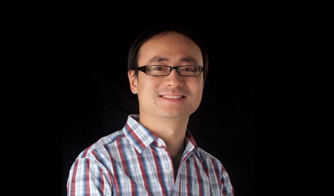 Chong Fang, standing in front of black backdrop