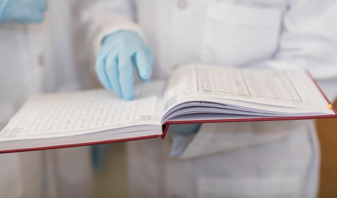 Scientist holding a lab book.
