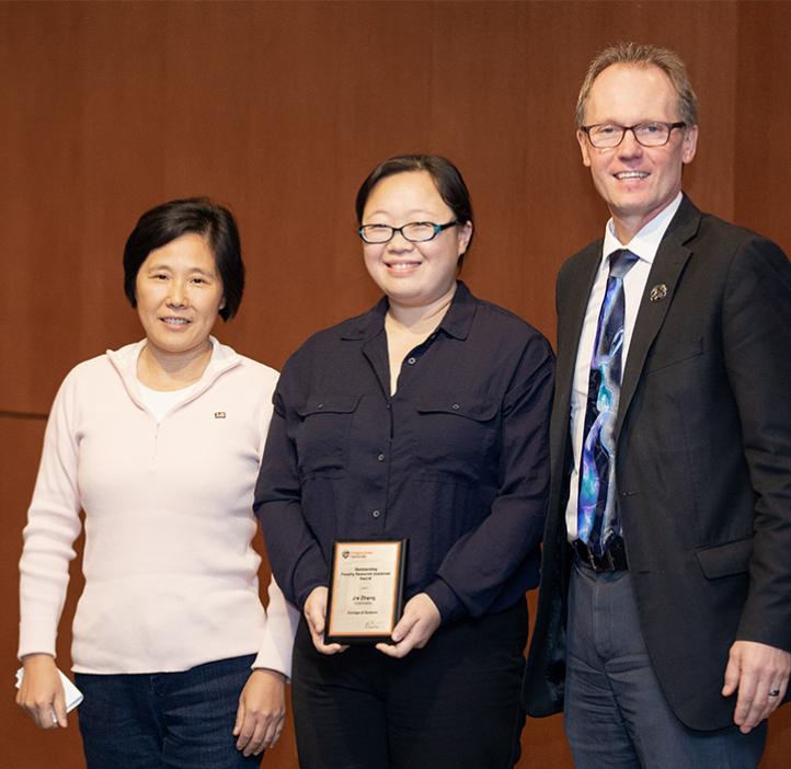 Jie Zhang (center) with Chemistry Professor Wei Kong and Dean Roy Haggerty
