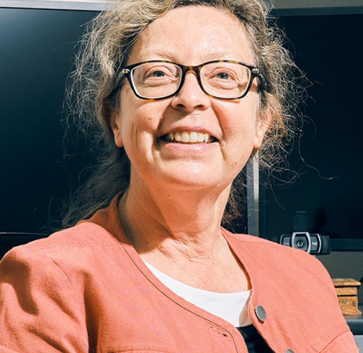 Headshot of Claudia Maier smiling in her office